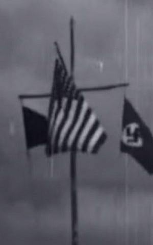 Three flags are flown during a 25-minute film taken at a Nazi youth camp in the United States in 1937: the camp emblem, the American flag, and the swastika. (YouTube screenshot)
