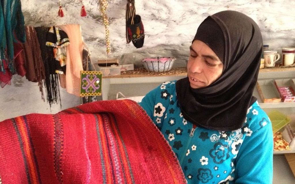 Widad Nawajah displays a rug woven locally in Susya, July 19, 2015 Elhanan Miller/Times of Israel