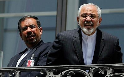 Iranian Foreign Minister Mohammad Javad Zarif, right, talks to a journalist from a balcony of the Palais Coburg hotel where the Iran nuclear talks are being held in Vienna, Austria, Friday, July 10, 2015. (Carlos Barria/Pool via AP)