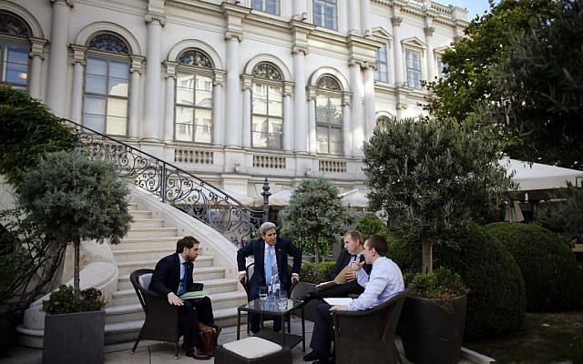US Secretary of State John Kerry, center, and State Department Chief of Staff Jon Finer, left, meet with other members of the US delegation at the garden of the Palais Coburg hotel where the Iran nuclear talks meetings are being held in Vienna, Austria, Friday July 10, 2015. (Carlos Barria/Pool via AP)