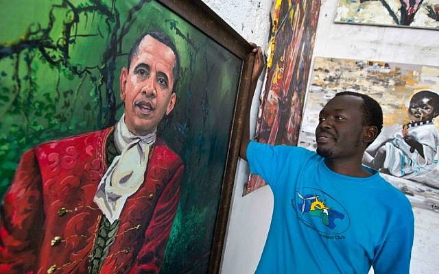 Kenyan artist Evans Yegon, known as "Yegonizer," poses by one of two paintings of President Barack Obama that he has completed in recent weeks, at his studio in the GoDown Arts Centre in Nairobi, Kenya Wednesday, July 22, 2015. (AP Photo/Ben Curtis)