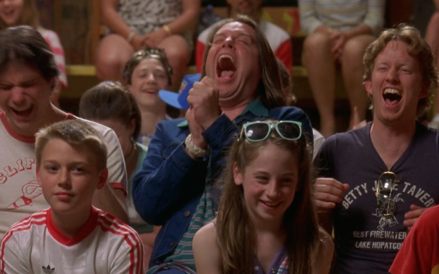 The crowd reacts to the comic stylings of the camp talent show MC in a scene from “Wet Hot American Summer” (Screen capture via YouTube)