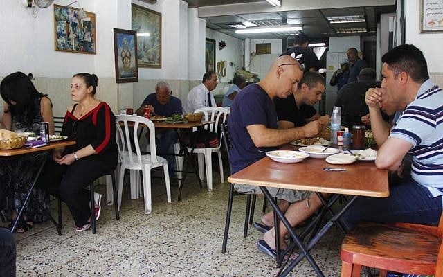 Patrons at Salimi tuck into generous portions of Persian rice and meat as the Iran nuclear agreement was being announced in Vienna. (Judah Ari Gross/Times of Israel)