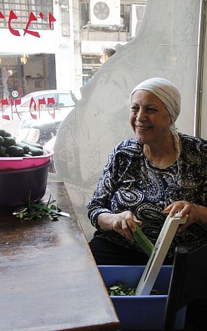 Moluk Hanasa, 65, the co-owner of Shamshiri restaurant on Nahalat Binyamin Street, wants to be optimistic that Iran will only use their nuclear energy for non-military purposes. (Judah Ari Gross/Times of Israel)