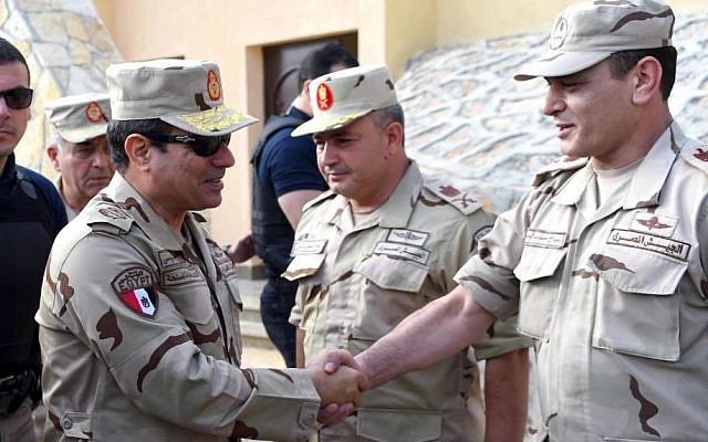 In this picture provided by the office of the Egyptian Presidency, Egyptian President Abdel-Fattah el-Sissi, second left, greets members of the Egyptian armed forces in Northern Sinai, Egypt, Saturday, July 4, 2015.(Egyptian Presidency /Mohammed Abdel-Muati via AP) In this picture provided by the office of the Egyptian Presidency, Egyptian President Abdel-Fattah el-Sissi, second left, greets members of the Egyptian armed forces in Northern Sinai, Egypt, Saturday, July 4, 2015.(Egyptian Presidency /Mohammed Abdel-Muati via AP)