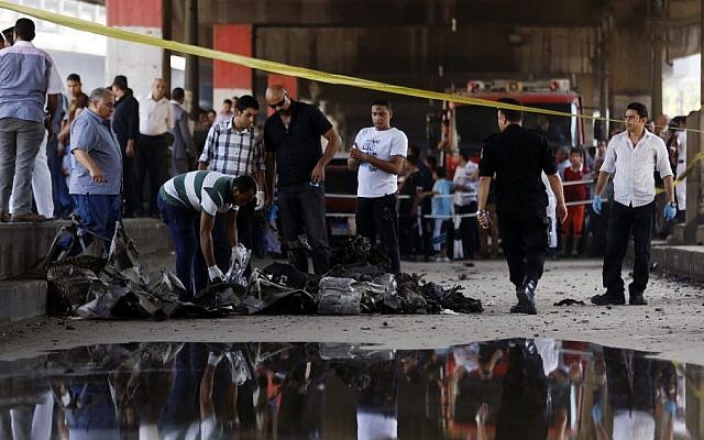 Egyptian investigators collect evidence at the base of the crumbled facade of the Italian consulate following a blast that killed at least one person in Cairo, Egypt, Saturday, July 11, 2015. (AP/Hassan Ammar) Egyptian investigators collect evidence at the base of the crumbled facade of the Italian consulate following a blast that killed at least one person in Cairo, Egypt, Saturday, July 11, 2015. (AP/Hassan Ammar)
