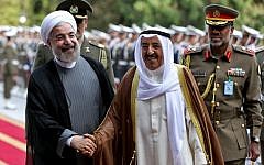 File: Kuwait's emir, Sheikh Sabah Al Ahmad Al Sabah, right, shakes hands with Iranian President Hassan Rouhani during a reception ceremony at the Saadabad Palace in Tehran, Iran, June 1, 2014 (AP/Ebrahim Noroozi, File)