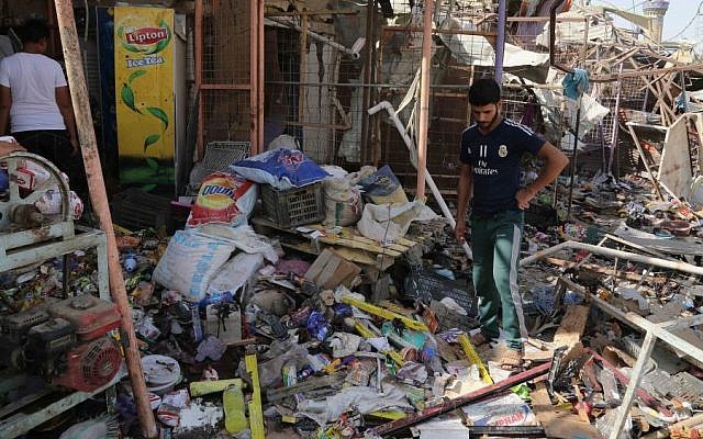 Civilians gather at the scene of a suicide car bombing at a busy market in Khan Bani Saad in the Diyala province, about 20 miles (30 kilometers) northeast of Baghdad, Iraq, Saturday, July 18, 2015. (AP/Karim Kadim) Civilians gather at the scene of a suicide car bombing at a busy market in Khan Bani Saad in the Diyala province, about 20 miles (30 kilometers) northeast of Baghdad, Iraq, Saturday, July 18, 2015. (AP/Karim Kadim)
