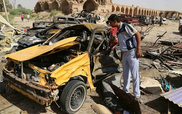 A civilian inspects the aftermath of a suicide car bombing claimed by Islamic State at a busy market in Khan Bani Saad in the Diyala province, about 20 miles (30 kilometers) northeast of Baghdad, Iraq, July 18, 2015. (AP/Karim Kadim) A civilian inspects the aftermath of a suicide car bombing claimed by Islamic State at a busy market in Khan Bani Saad in the Diyala province, about 20 miles (30 kilometers) northeast of Baghdad, Iraq, July 18, 2015. (AP/Karim Kadim)