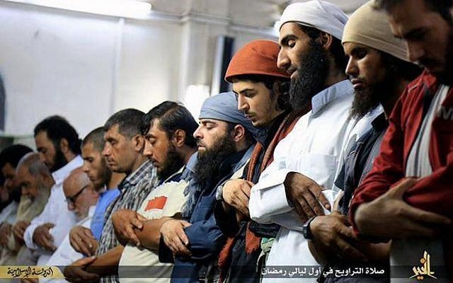 In this Saturday, June 20, 2015 photo provided by a website of the Islamic State group, Muslims perform "Taraweeh," a special night's prayers during the Muslim holy month of Ramadan, in the eastern city of Deir el-Zour, Syria. (Islamic State militant via AP)
