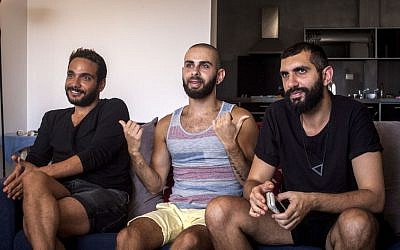 This Monday, July 27, 2015 photo shows Khader Abu Seif, from left, Naeem Jiryes and Fadi Daeem, protagonists of the documentary movie "Oriented" during an interview with The Associated Press in Jaffa.  (AP Photo/Eyal Warshavsky)
