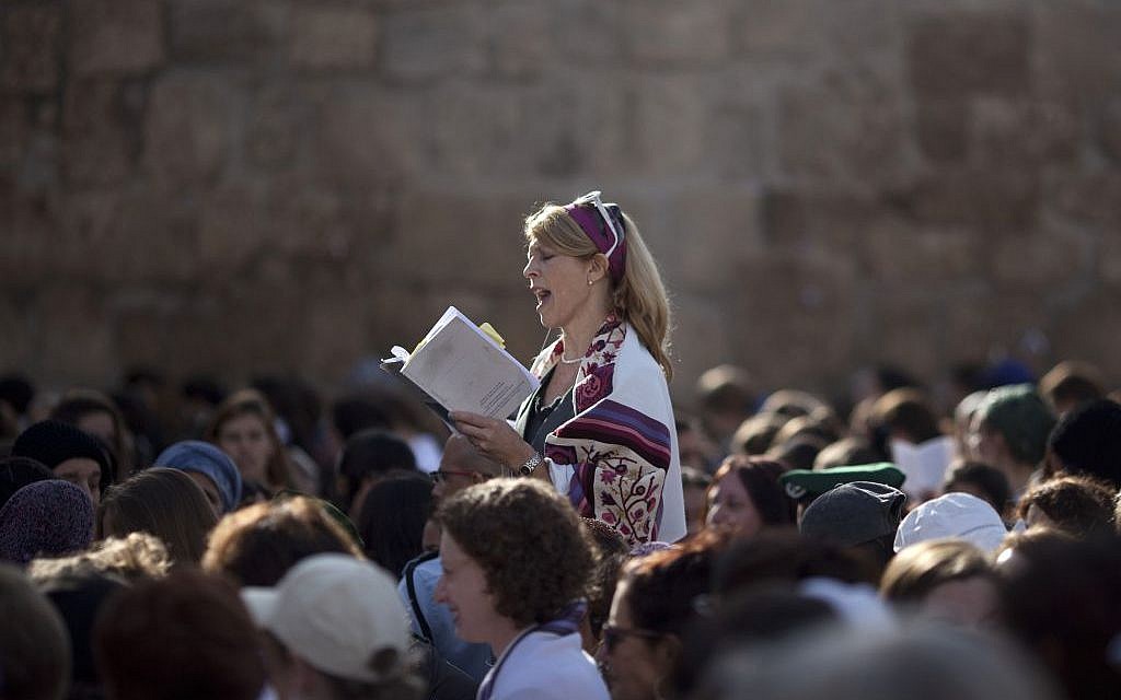 In this Monday, Nov. 4, 2013, file photo, a Jewish woman wears a prayer shawl as she prays at the Western Wall, the holiest site where Jews can pray in Jerusalem's Old City. (AP Photo/Ariel Schalit, File) In this Monday, Nov. 4, 2013, file photo, a Jewish woman wears a prayer shawl as she prays at the Western Wall, the holiest site where Jews can pray in Jerusalem's Old City. (AP Photo/Ariel Schalit, File)