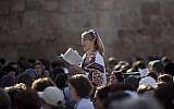 In this Monday, Nov. 4, 2013, file photo, a Jewish woman wears a prayer shawl as she prays at the Western Wall, the holiest site where Jews can pray in Jerusalem's Old City. (AP Photo/Ariel Schalit, File)