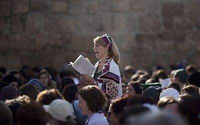 In this Monday, Nov. 4, 2013, file photo, a Jewish woman wears a prayer shawl as she prays at the Western Wall, the holiest site where Jews can pray in Jerusalem's Old City. (AP Photo/Ariel Schalit, File)