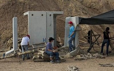 Israeli youth build a bonfire next to a bomb shelter during preparations to celebrate their Bar Mitzvah, in Kibbutz Beeri, southern Israel near the border with the Gaza Strip, June 23, 2015 (Oded Balilty/AP)