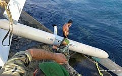 In this photo released by the Lebanese Army official website, Lebanese soldiers remove an Israeli drone they say crashed in the port of Tripoli, northern Lebanon, Saturday, July 11, 2015 (Lebanese Army Website via AP)