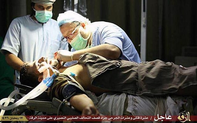 This Saturday, July, 4, 2015 photo provided by a website of the Islamic State group, shows a wounded man being treated by doctors in Raqqa, Syria. (Islamic State militant website via AP)