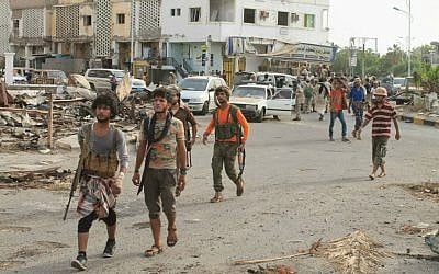 Fighters against Shiite rebels known as Houthis gather at a street in the port city of Aden, Yemen, Thursday, July 16, 2015. (AP Photo/Abo Muhammed)