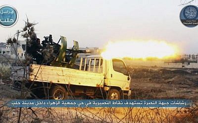 In this image posted on the Twitter page of Syria's al-Qaeda-linked Nusra Front on early Tuesday, July 7, 2015, a fighter from the al-Nusra Front fires a weapon during clashes with Syrian government forces in Aleppo, Syria. (Al-Nusra Front via AP)