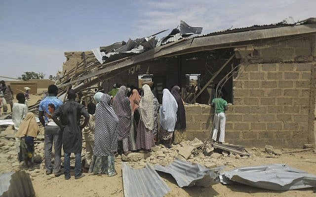 People gather at the site of a suicide bomb attack at Redeem Christian Church in Potiskum, Nigeria, which has been blamed on Boko Haram, July 5, 2015. (Adamu Adamu/AP Photo) People gather at the site of a suicide bomb attack at Redeem Christian Church in Potiskum, Nigeria, which has been blamed on Boko Haram, July 5, 2015. (Adamu Adamu/AP Photo)