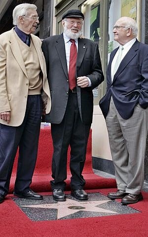 In this 2005 file photo, Theodore Bikel, center, with fellow actors Martin Landau, left, and Ed Asner, pose for photos during a dedication ceremony for Bikel's star on the Hollywood Walk of Fame in Los Angeles. (Reed Saxon/AP Photo, File)