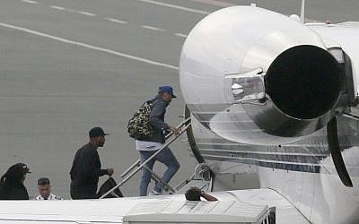 Grammy award-winning singer Chris Brown boards a chartered jet at the old Manila Domestic Airport in suburban Pasay city, south of Manila, Philippines, Friday, July 24, 2015. (AP/Bullit Marquez)