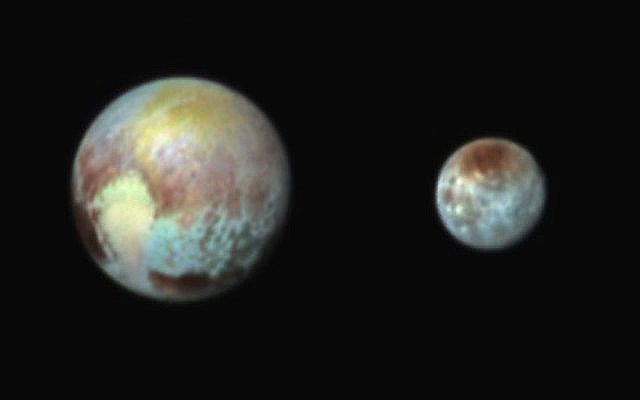 This Monday, July 13, 2015 combination image released by NASA shows Pluto, left, and its moon, Charon, with differences in surface material and features depicted in exaggerated colors made by using different filters on a camera aboard the New Horizons spacecraft. (NASA/APL/SwRI via AP)