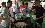 Vendors selling falafel at the nightly Ramadan market in Kfar Qasim. (Ben Sales)
