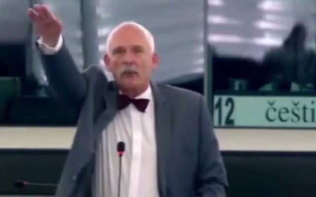 Polish European MP Janusz Korwin-Mikke makes the Hitler salute on Wednesday, July 8, 2015 (screen capture:YouTube)