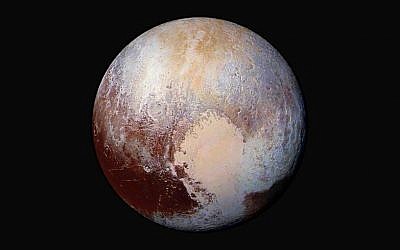 This image made available by NASA on Friday, July 24, 2015 shows a combination of images captured by the New Horizons spacecraft with enhanced colors to show differences in the composition and texture of Pluto's surface. The images were taken when the spacecraft was 280,000 miles (450,000 kilometers) away. (NASA/JHUAPL/SwRI via AP)