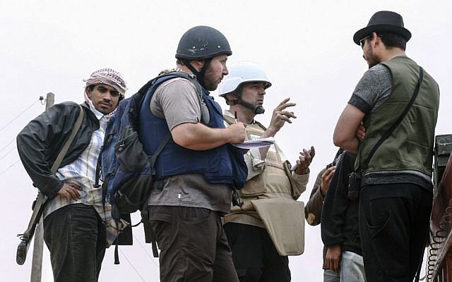 In this handout image made available by the photographer, American journalist Steven Sotloff, center with black helmet, talks to Libyan rebels on the Al Dafniya front line, about 15 miles from Misrata, Libya, June 2, 2011. Sotloff was beheaded in September 2014 nearly a year after being kidnapped in Syria. (Etienne de Malglaive via Getty Images/JTA) In this handout image made available by the photographer, American journalist Steven Sotloff, center with black helmet, talks to Libyan rebels on the Al Dafniya front line, about 15 miles from Misrata, Libya, June 2, 2011. Sotloff was beheaded in September 2014 nearly a year after being kidnapped in Syria. (Etienne de Malglaive via Getty Images/JTA)