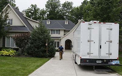 Federal authorities walk into the home of Subway restaurant spokesman Jared Fogle, Tuesday, July 7, 2015, in Zionsville, Ind. (AP Photo/Michael Conroy)