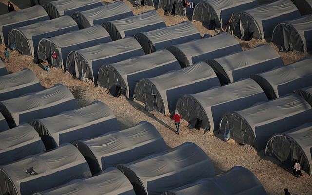In this Oct, 17, 2014, file photo, Syrian Kurdish refugees who fled fighting in Kobani, Syria, go about at a refugee camp in Suruc, on the Turkey-Syria border. (AP Photo/Lefteris Pitarakis, File)