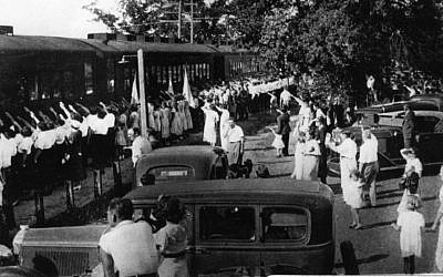 The 'Camp Siegfried Special' train arrives in Yaphank, Long Island, welcomed by Hitler salutes from those waiting on the train platform. (Town of Brookhaven Historical Society)