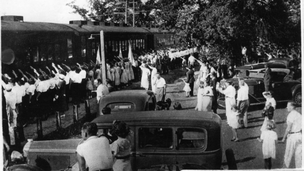 The 'Camp Siegfried Special' train arrives in Yaphank, Long Island, welcomed by Hitler salutes from those waiting on the train platform. (Town of Brookhaven Historical Society) The 'Camp Siegfried Special' train arrives in Yaphank, Long Island, welcomed by Hitler salutes from those waiting on the train platform. (Town of Brookhaven Historical Society)