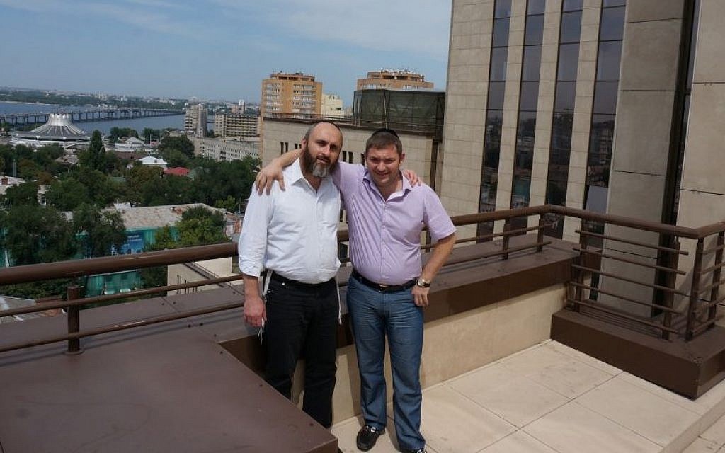 Zelig Brez, left, the director of the Jewish Community of Dneproptrovsk, with a local donor, Natan Zolotarevsky, on the roof of the Menorah Center in the eastern Ukraine city, July 15, 2014. (Cnaan Liphshiz/JTA) Zelig Brez, left, the director of the Jewish Community of Dneproptrovsk, with a local donor, Natan Zolotarevsky, on the roof of the Menorah Center in the eastern Ukraine city, July 15, 2014. (Cnaan Liphshiz/JTA)