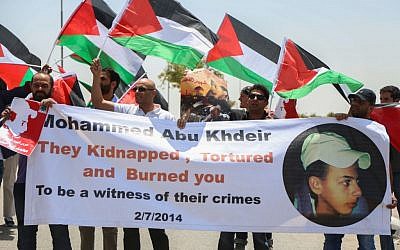 Palestinian protesters block a road leading to the Adam settlement during a demonstration to mark the first anniversary of the killing of 16-year-old Palestinian Mohammed Abu Khder on July 2, 2015. Photo by Flash90