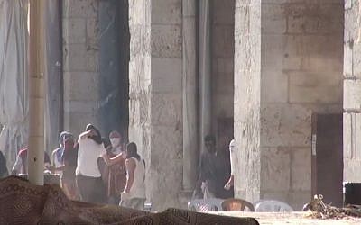 Palestinian rioters hurl rocks at Israeli Police in front of the al-Aqsa Mosque on the Temple Mount in Jerusalem on Sunday, July 26, 2015. (screen capture: Israel Police video) Palestinian rioters hurl rocks at Israeli Police in front of the al-Aqsa Mosque on the Temple Mount in Jerusalem on Sunday, July 26, 2015. (screen capture: Israel Police video)
