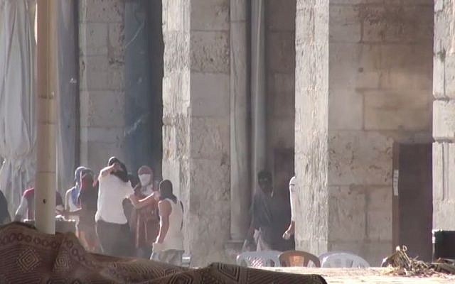 Palestinian rioters hurl rocks at Israeli Police in front of the al-Aqsa Mosque on the Temple Mount in Jerusalem on Sunday, July 26, 2015. (screen capture: Israel Police video) Palestinian rioters hurl rocks at Israeli Police in front of the al-Aqsa Mosque on the Temple Mount in Jerusalem on Sunday, July 26, 2015. (screen capture: Israel Police video)