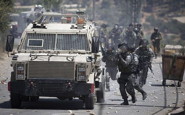 IDF soldiers clash with Palestinians after the funeral of Falah Abu Maria in the village of Beit Omar near the West Bank city of Hebron, Thursday, July 23, 2015. (AP Photo/Majdi Mohammed) IDF soldiers clash with Palestinians after the funeral of Falah Abu Maria in the village of Beit Omar near the West Bank city of Hebron, Thursday, July 23, 2015. (AP Photo/Majdi Mohammed)