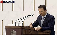 Syrian President Bashar Assad delivering a speech in Damascus, Syria on Sunday, July 26, 2015. (Press TV via AP video)