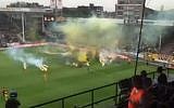 Smoke bombs and flares are thrown onto the pitch by fans of Beitar Jerusalem soccer club during an away match against Belgian team Sporting Charleroi on July 16, 2015. (screenshot: Ynet)