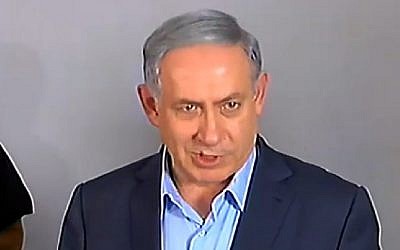 Prime Minister Benjamin Netanyahu speaks to reporters on July 10, 2015 outside the family home of Avraham Mensigu, an Israeli captive held in Gaza. (Screen capture/Channel 2)