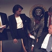 Dick Cheney is surrounded by administration members, including Condoleezza Rice, as he talks on the phone in the President's Emergency Operations Center in the White House on September 11, 2001. (photo credit: US National Archives)