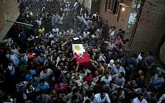 Egyptians carry the coffin of 1st Lt. Mohammed Adel Abdel Azeem -- killed on July 1, 2015, in an attack by Islamic extremists in the Sinai -- during the funeral procession in his home village of Tant al-Jazeera, north of Cairo, Egypt, July 2, 2015. (Hassan Ammar)