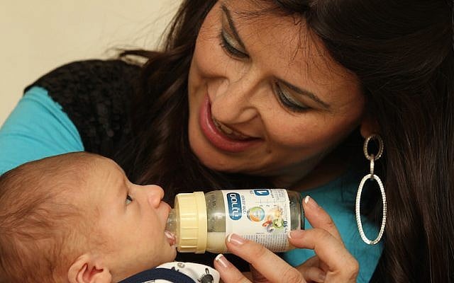 A mother feeds her two week old baby with milk substitute. (Nati Shohat/Flash90) A mother feeds her two week old baby with milk substitute. (Nati Shohat/Flash90)