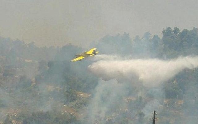 A firefighting aircraft operates near Kibbutz Ma'ale Hahamisha outside Jerusalem, July 4, 2015, to put out a fire that authorities suspect was arson. (Israel Fire and Rescue Services) A firefighting aircraft operates near Kibbutz Ma'ale Hahamisha outside Jerusalem, July 4, 2015, to put out a fire that authorities suspect was arson. (Israel Fire and Rescue Services)