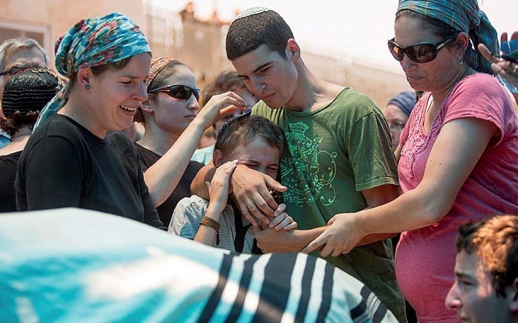 The family of Malachy Rosenfeld mourn during his funeral in Kochav Hashachar in the West Bank on July 01, 2015. (Yonatan Sindel/Flash90) The family of Malachy Rosenfeld mourn during his funeral in Kochav Hashachar in the West Bank on July 01, 2015. (Yonatan Sindel/Flash90)