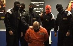 Image taken from the video of HSBC staff in Birmingham performing a mock Islamic State execution. (Screen capture: The Sun)