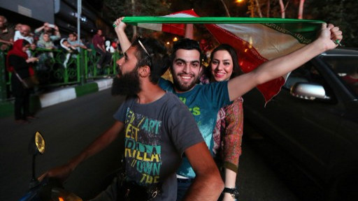 Iranians wave the national flag during celebrations in northern Tehran on July 14, 2015, after Iran's nuclear negotiating team struck a deal with world powers in Vienna (AFP/ATTA KENARE) Iranians wave the national flag during celebrations in northern Tehran on July 14, 2015, after Iran's nuclear negotiating team struck a deal with world powers in Vienna (AFP/ATTA KENARE)